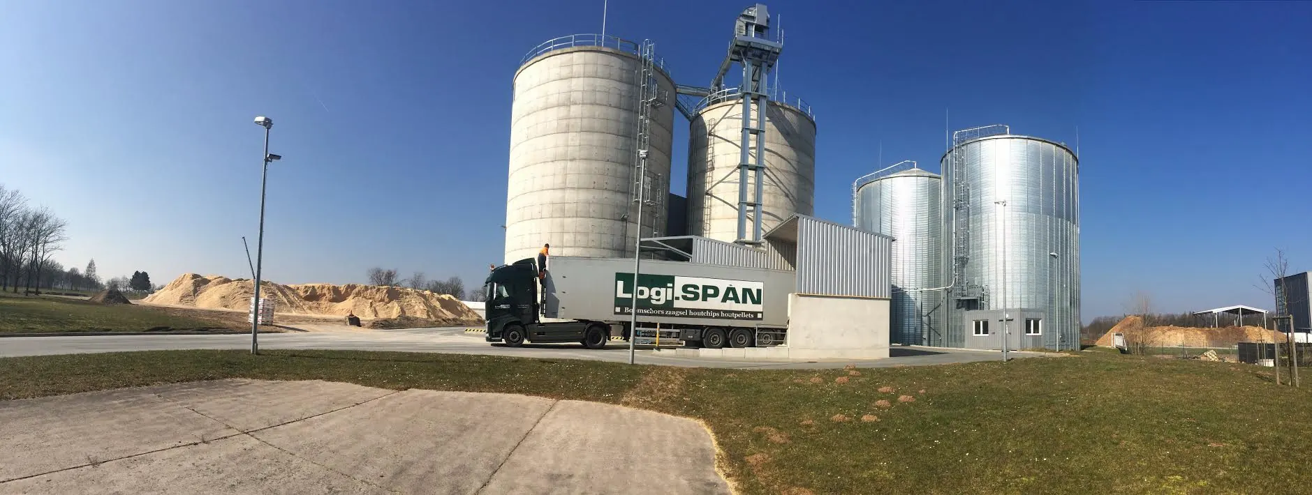 Wood pellet plant with storage silos and truck loading